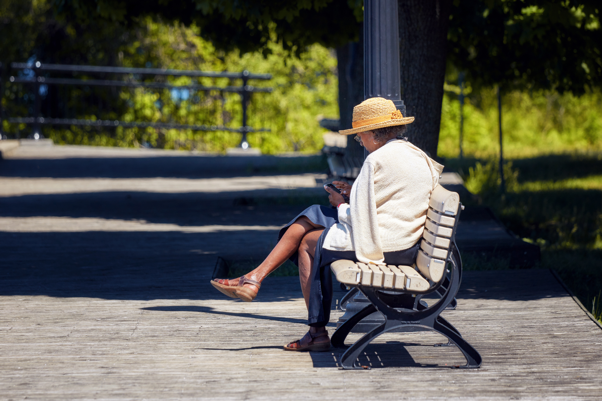 Senior resident relaxing on a boardwalk bench