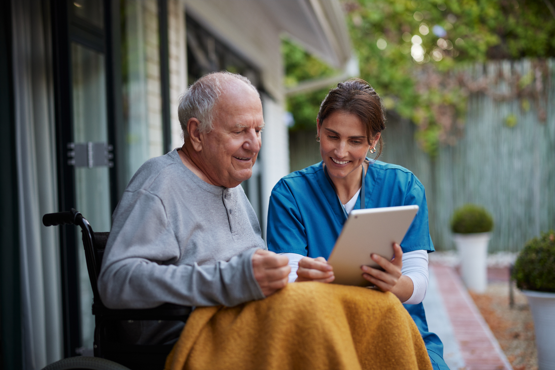 Caregiver holding a resident's hand